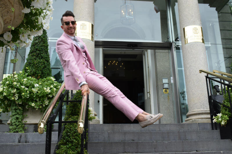 Sliding down the stairs in a pink suit